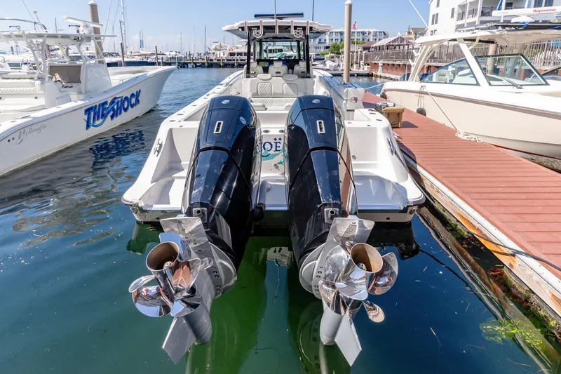  Yacht Photos Pics 2024 HCB 39 Speciale boat with twin outboard engines docked at a marina.