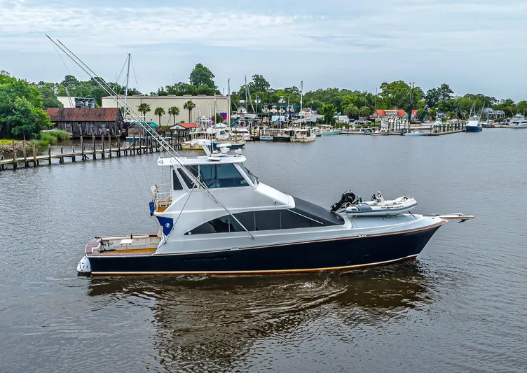 Double Down Yacht Photos Pics 1997 Ocean Yachts 60 Super Sport EB cruising in a marina with scenic background.