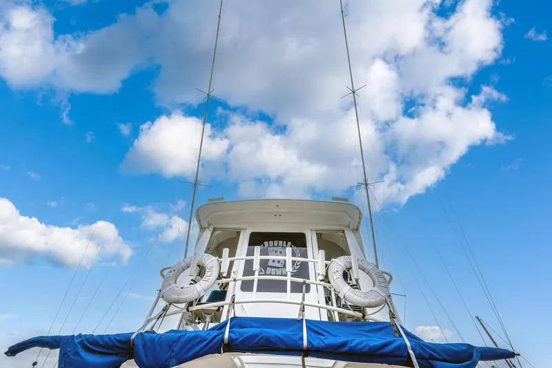 Double Down Yacht Photos Pics 1997 Ocean Yachts 60 Super Sport EB against a bright blue sky with clouds.