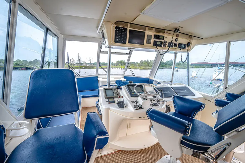 Double Down Yacht Photos Pics Cockpit of 1997 Ocean Yachts 60 Super Sport EB with blue seating and navigation equipment.