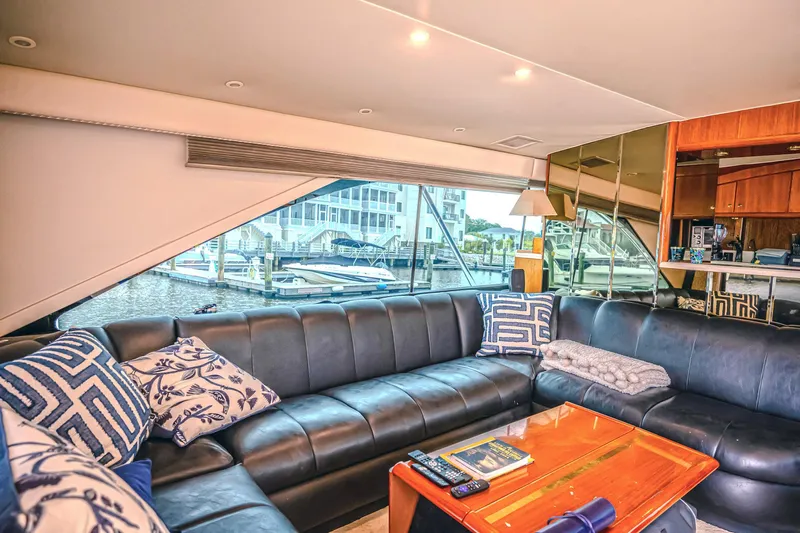 Double Down Yacht Photos Pics Luxurious interior of 1997 Ocean Yachts 60 Super Sport EB with plush seating and marina view.