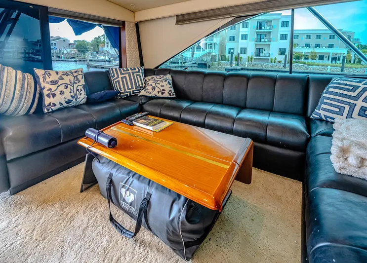 Double Down Yacht Photos Pics Luxurious interior of 1997 Ocean Yachts 60 Super Sport EB with leather seating and wooden table.