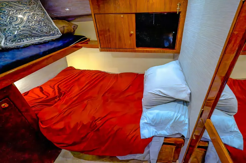 Double Down Yacht Photos Pics Cozy cabin interior of 1997 Ocean Yachts 60 Super Sport EB with red bedding.