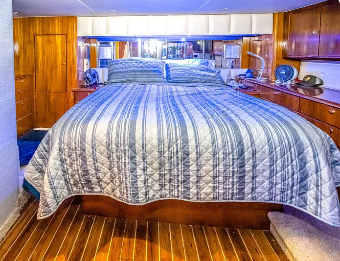 Double Down Yacht Photos Pics Luxurious bedroom interior of 1997 Ocean Yachts 60 Super Sport EB with striped bedding.