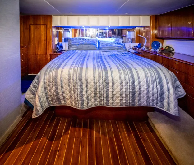 Double Down Yacht Photos Pics Luxurious bedroom interior of 1997 Ocean Yachts 60 Super Sport EB with striped bedding.