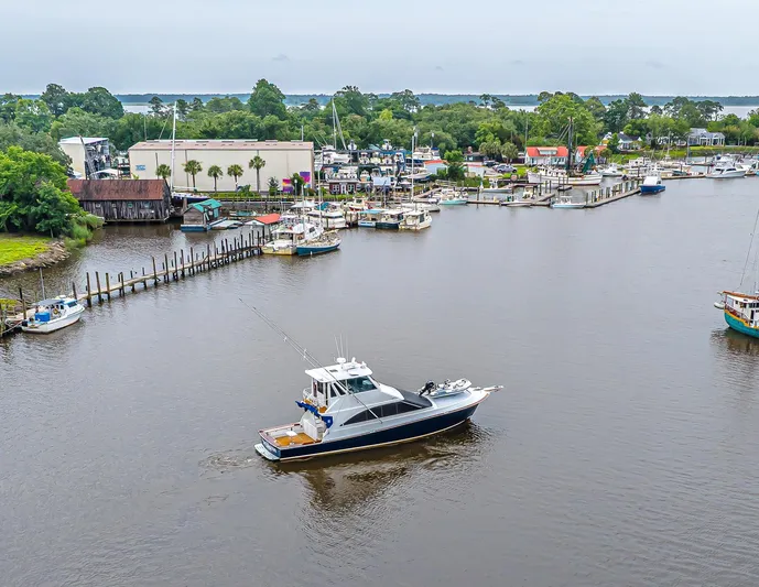 Double Down Yacht Photos Pics Aerial view of 1997 Ocean Yachts 60 Super Sport EB cruising near a marina.
