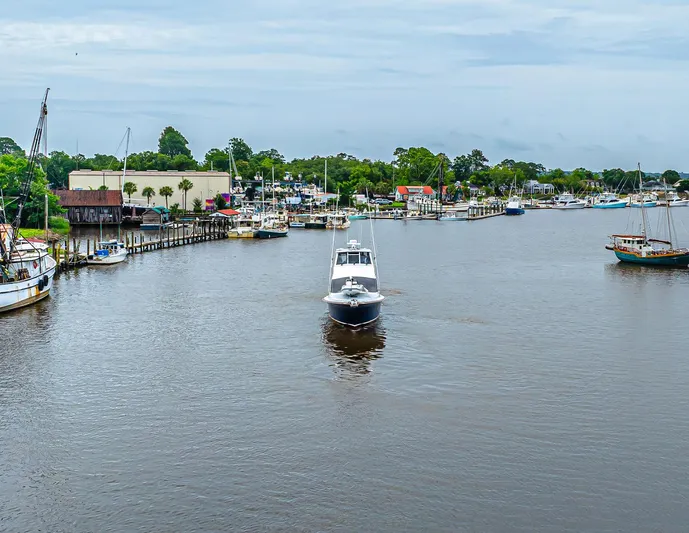 Double Down Yacht Photos Pics A 1997 Ocean Yachts 60 Super Sport EB cruising in a scenic harbor.