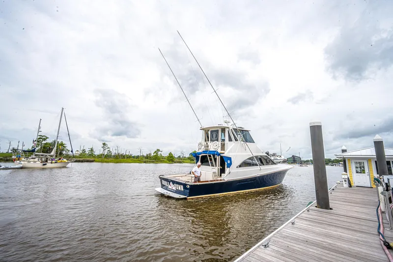 Double Down Yacht Photos Pics 1997 Ocean Yachts 60 Super Sport EB docked at a marina under cloudy skies.