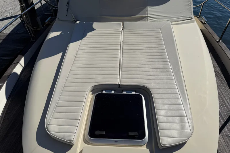 Landfall Yacht Photos Pics Sunbathing deck on 2013 Greenline 33 yacht with cushioned seating and hatch.