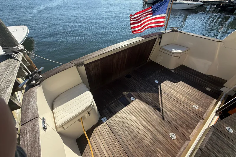 Landfall Yacht Photos Pics 2013 Greenline 33 boat deck with American flag, docked by the water.