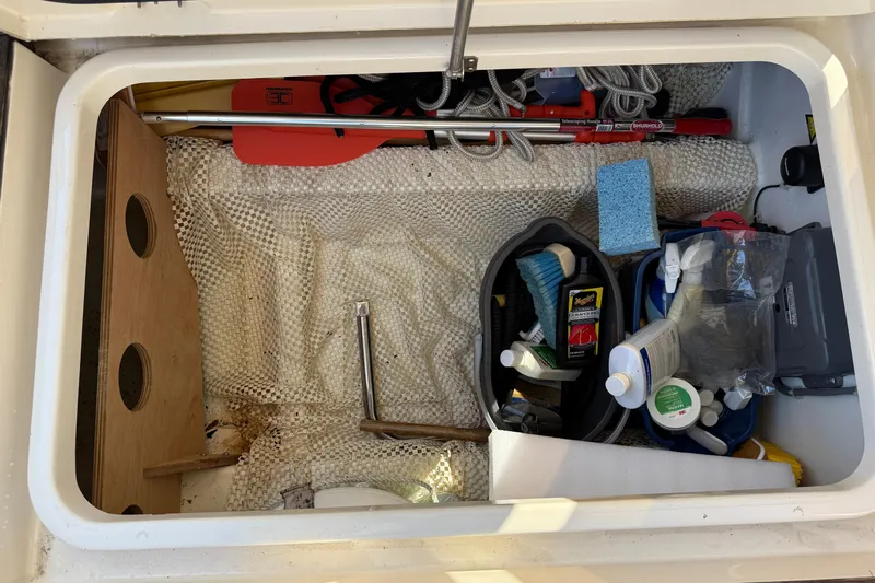 Landfall Yacht Photos Pics Storage compartment on a 2013 Greenline 33 boat with cleaning supplies and tools.