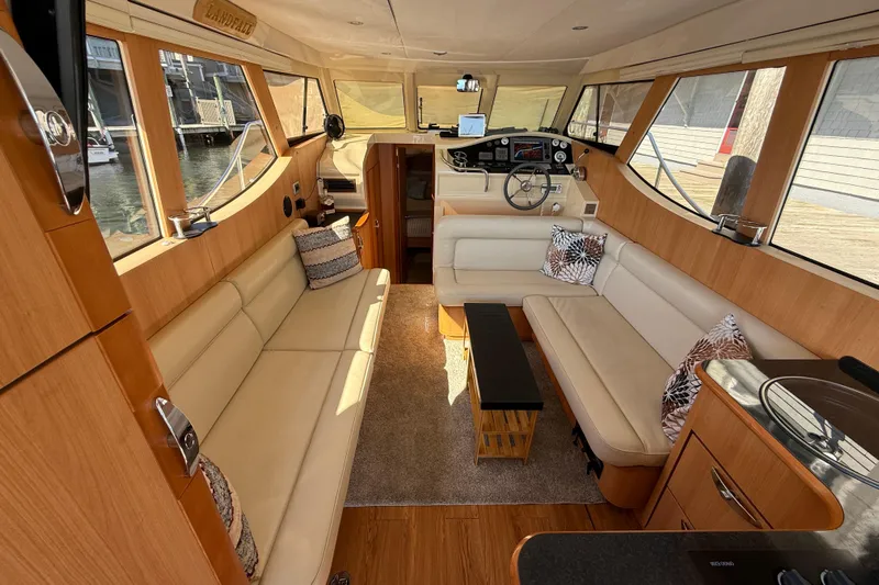 Landfall Yacht Photos Pics Interior of 2013 Greenline 33 yacht with beige seating and wooden accents.