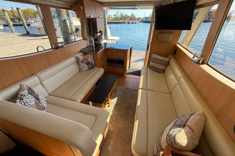 Landfall Yacht Photos Pics Luxurious interior of 2013 Greenline 33 yacht with beige seating and waterfront view.
