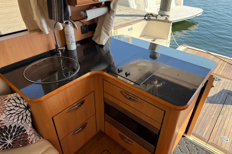Landfall Yacht Photos Pics Compact kitchen area in a 2013 Greenline 33 yacht with stove and sink.