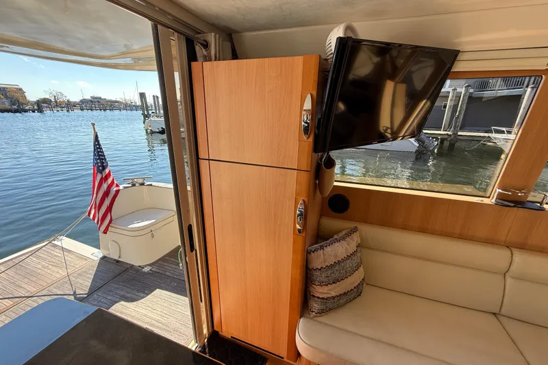 Landfall Yacht Photos Pics Interior of 2013 Greenline 33 yacht with TV, seating, and water view.