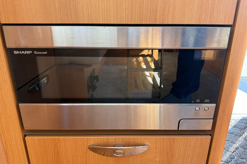 Landfall Yacht Photos Pics Sharp Carousel microwave in a 2013 Greenline 33 interior, featuring a sleek wood finish.