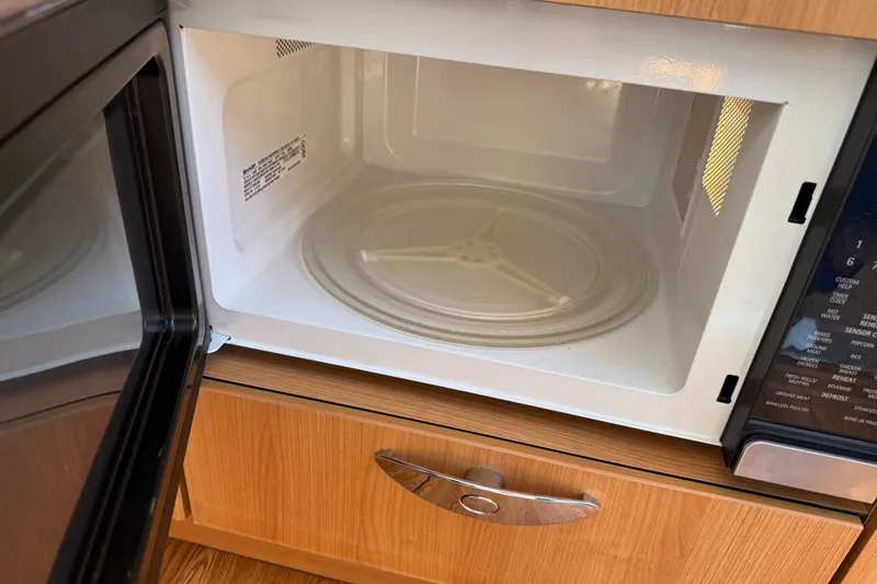 Landfall Yacht Photos Pics Open microwave oven with wooden cabinetry, Greenline 33, 2013 model.