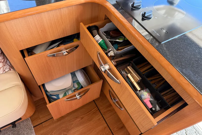 Landfall Yacht Photos Pics Kitchen drawers in a 2013 Greenline 33 yacht, containing utensils and cookware.