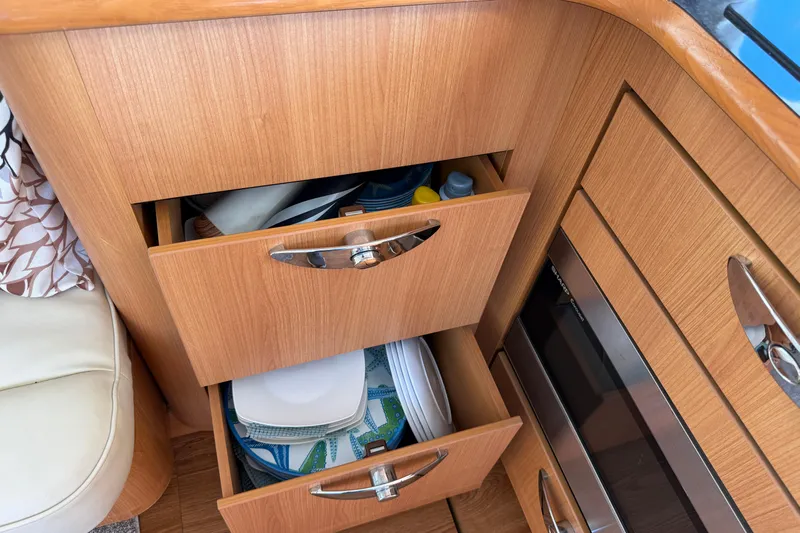 Landfall Yacht Photos Pics Wooden kitchen drawers in a 2013 Greenline 33 boat, storing plates and supplies.
