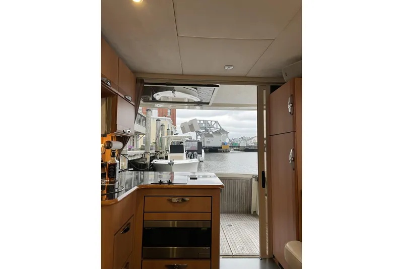 Landfall Yacht Photos Pics Interior view of 2013 Greenline 33 yacht kitchen with marina backdrop.
