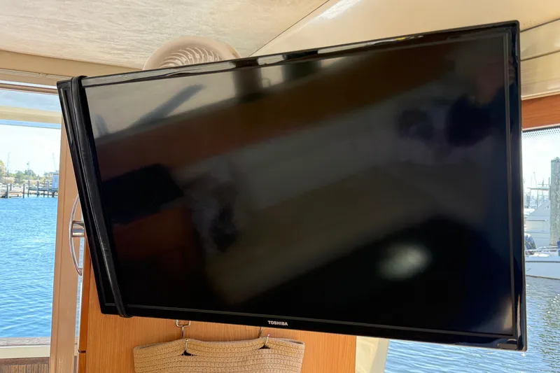 Landfall Yacht Photos Pics Toshiba TV inside 2013 Greenline 33 yacht, with marina view through window.