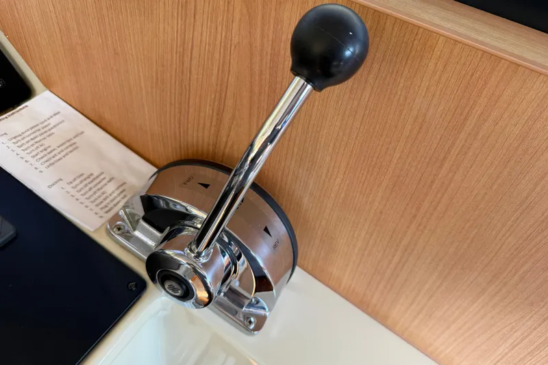 Landfall Yacht Photos Pics Throttle control lever on a 2013 Greenline 33 boat, mounted on a wooden panel.