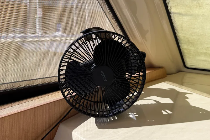 Landfall Yacht Photos Pics Black fan inside a 2013 Greenline 33 boat, placed near a window.