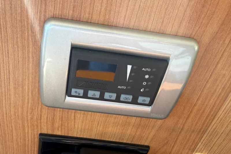 Landfall Yacht Photos Pics Control panel on 2013 Greenline 33 yacht, mounted on wooden surface.