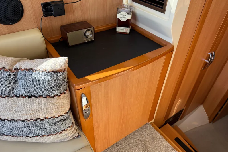 Landfall Yacht Photos Pics Interior of 2013 Greenline 33 yacht with wooden cabinetry and cozy seating area.