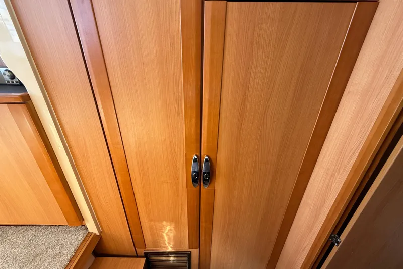 Landfall Yacht Photos Pics Wooden interior of 2013 Greenline 33 yacht, featuring sleek cabinetry and modern design.