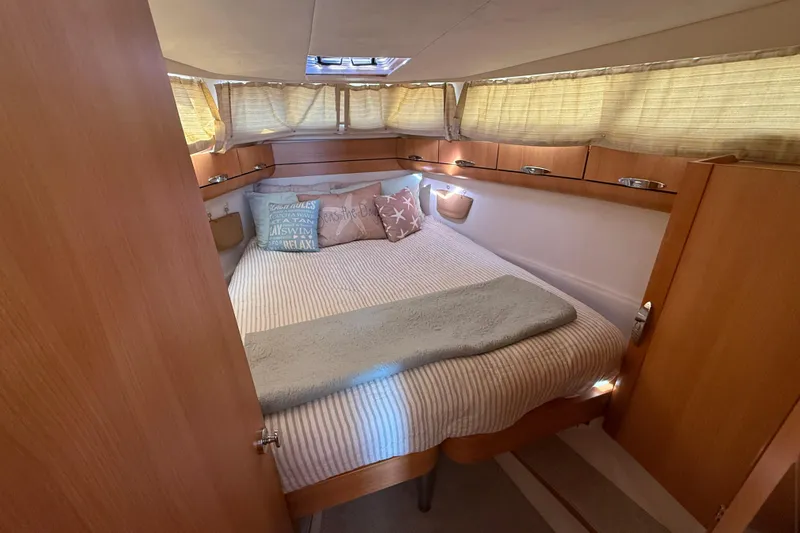Landfall Yacht Photos Pics Cozy cabin interior of 2013 Greenline 33 yacht with bed and wooden furnishings.