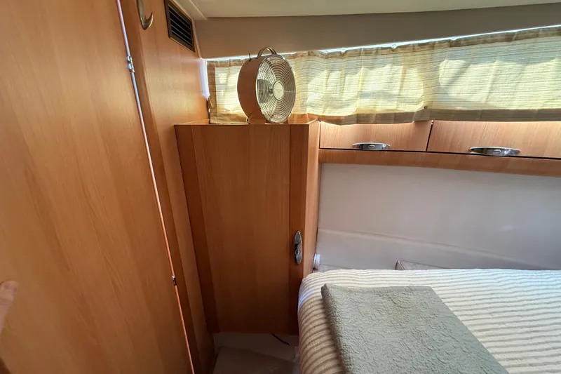 Landfall Yacht Photos Pics Cozy cabin interior of 2013 Greenline 33 yacht with wooden furnishings and a small fan.