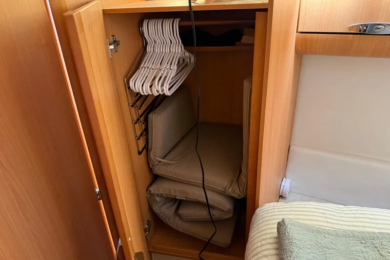 Landfall Yacht Photos Pics Cabinet interior on 2013 Greenline 33 boat with hangers and folded cushions.