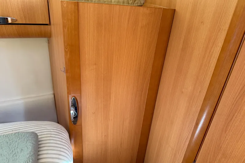 Landfall Yacht Photos Pics Interior of 2013 Greenline 33 boat with wooden cabinetry and bedding.