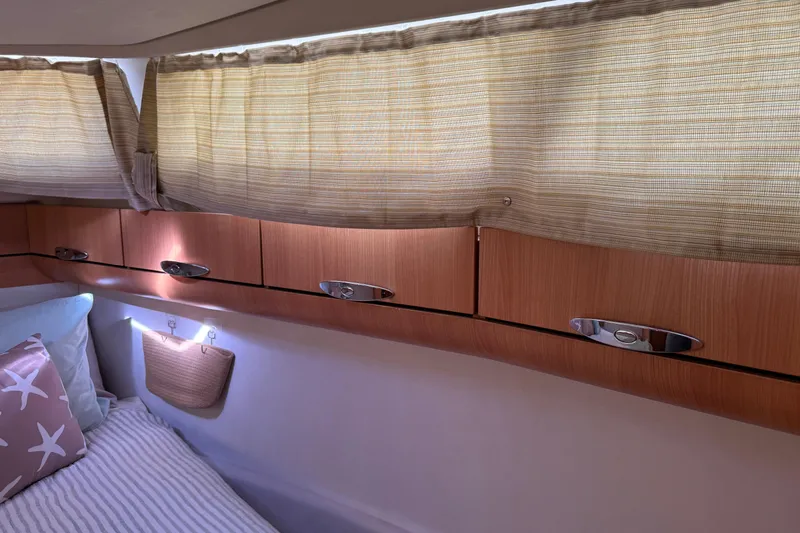 Landfall Yacht Photos Pics Cozy cabin interior of 2013 Greenline 33 yacht with wooden cabinets and soft lighting.