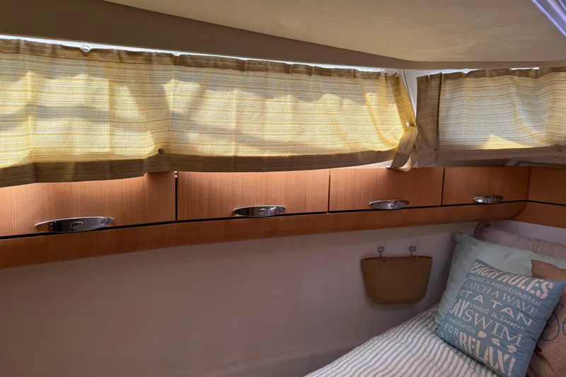 Landfall Yacht Photos Pics Cozy cabin interior of 2013 Greenline 33 yacht with wooden cabinets and soft lighting.