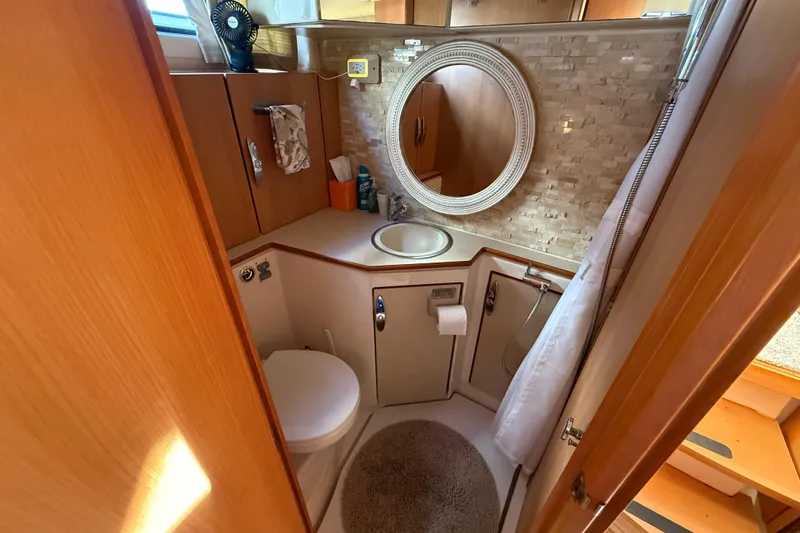 Landfall Yacht Photos Pics Compact bathroom in 2013 Greenline 33 yacht with round mirror and modern fixtures.