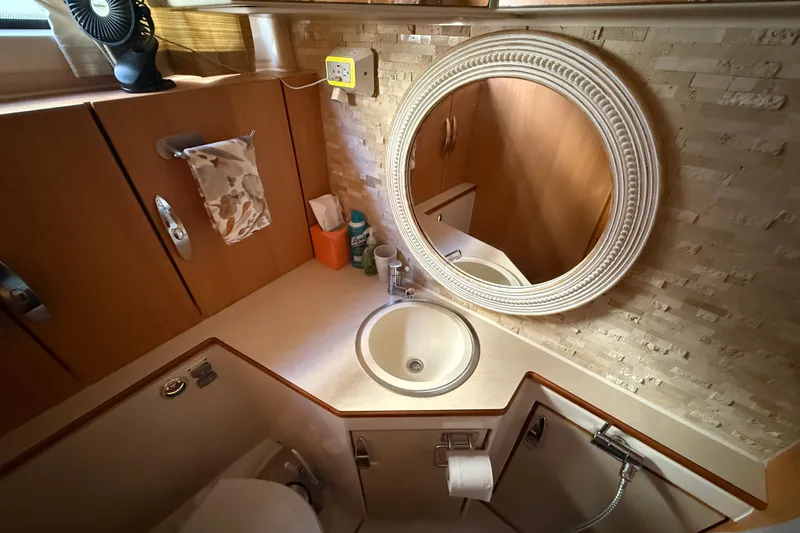 Landfall Yacht Photos Pics Bathroom interior of 2013 Greenline 33 yacht with round mirror and sink.