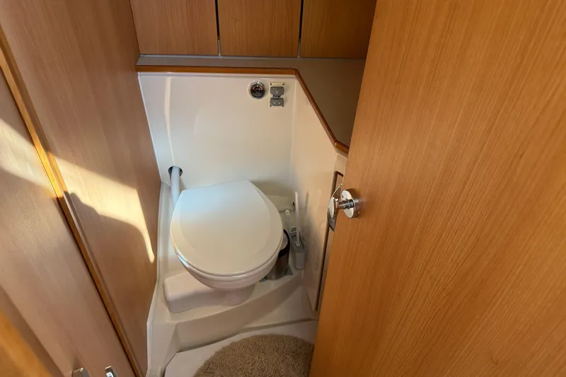 Landfall Yacht Photos Pics Compact bathroom in 2013 Greenline 33 yacht with wooden cabinetry and modern toilet.