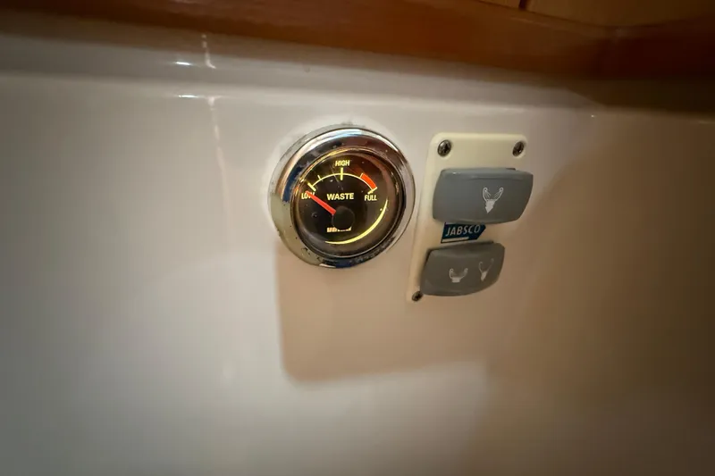 Landfall Yacht Photos Pics Waste level gauge and Jabsco controls on 2013 Greenline 33 boat interior.