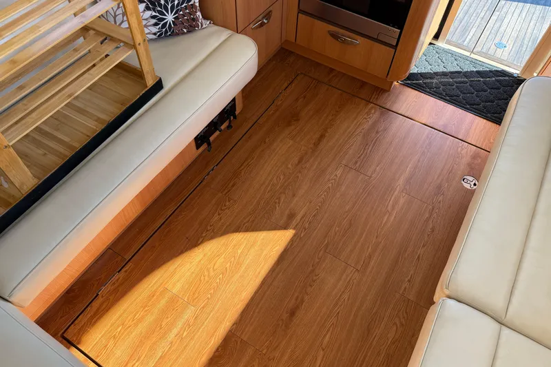 Landfall Yacht Photos Pics Interior of 2013 Greenline 33 yacht with wooden flooring and beige seating.
