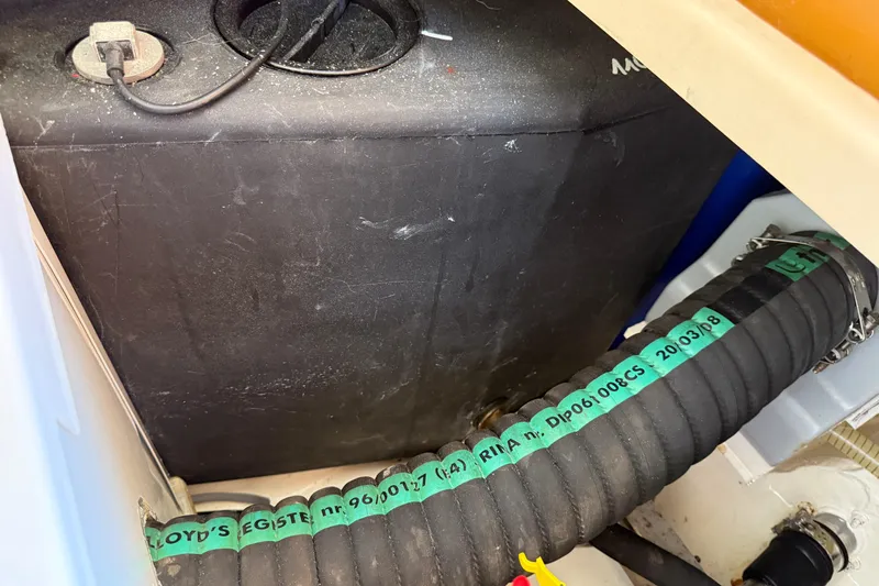 Landfall Yacht Photos Pics Engine compartment of a 2013 Greenline 33 boat with visible hoses and wiring.