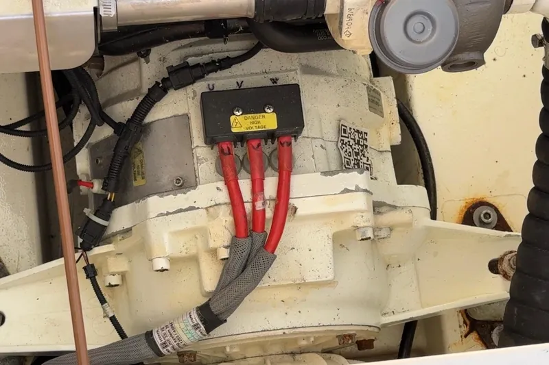 Landfall Yacht Photos Pics Engine compartment of a 2013 Greenline 33 with visible wiring and high voltage warning.