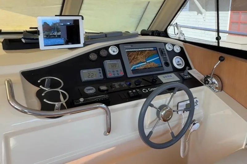 Landfall Yacht Photos Pics Helm of 2013 Greenline 33 yacht with navigation equipment and steering wheel.