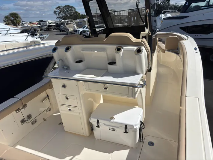  Yacht Photos Pics 2025 Scout 260 LXF boat interior with seating, storage, and cooler.