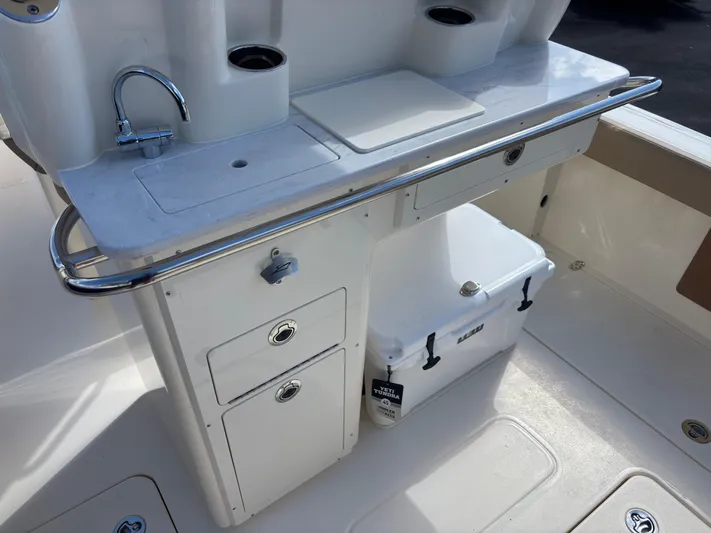  Yacht Photos Pics 2025 Scout 260 LXF boat interior with sink, storage, and cooler.