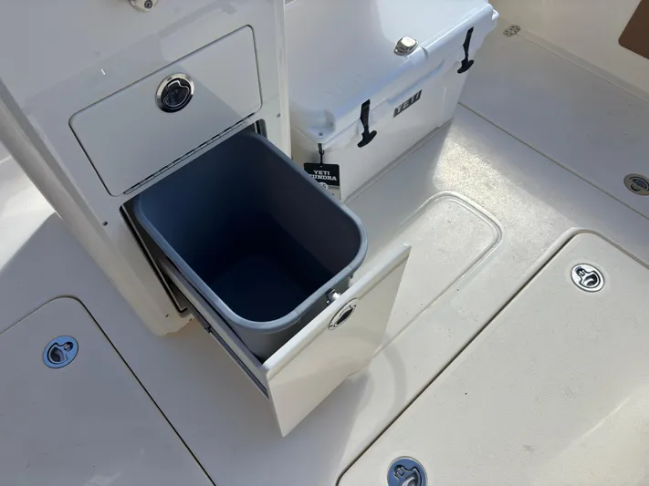  Yacht Photos Pics 2025 Scout 260 LXF boat interior with storage compartment and cooler.