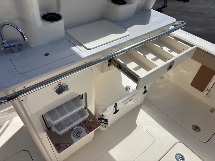 Yacht Photos Pics 2025 Scout 260 LXF boat interior with storage compartments and sink.