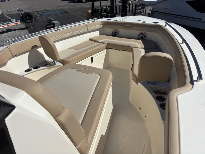  Yacht Photos Pics 2025 Scout 260 LXF boat interior with beige seating and cup holders.