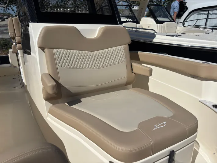  Yacht Photos Pics 2025 Scout 260 LXF boat seat with beige and cream upholstery, featuring diamond stitching.